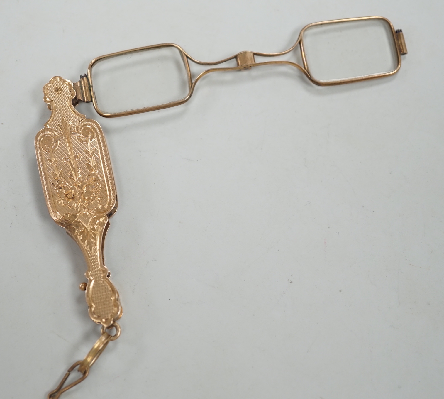A pair of early 20th century engraved yellow metal overlaid lorgnettes.